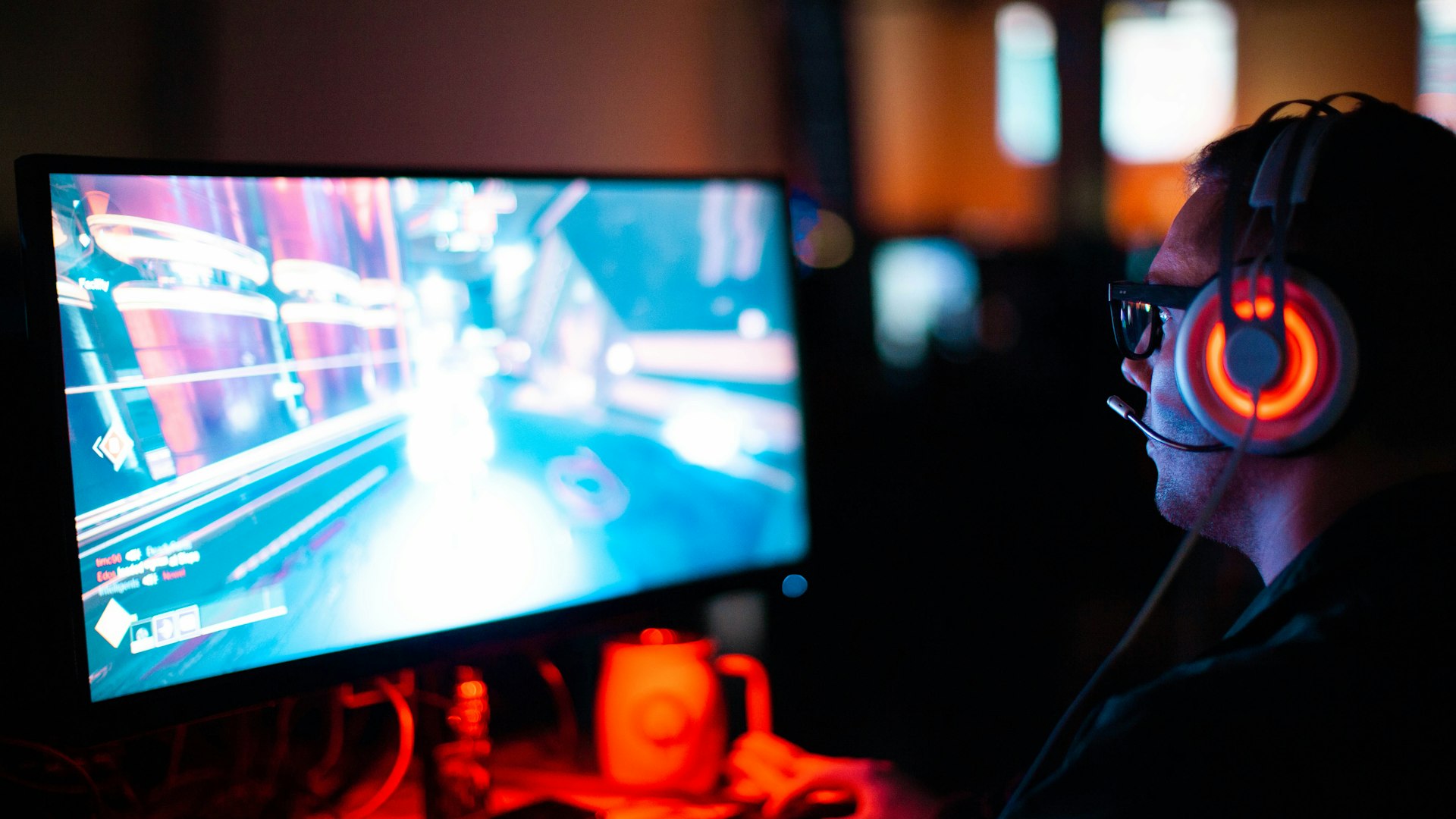 A retro gaming setup lit in pink neon